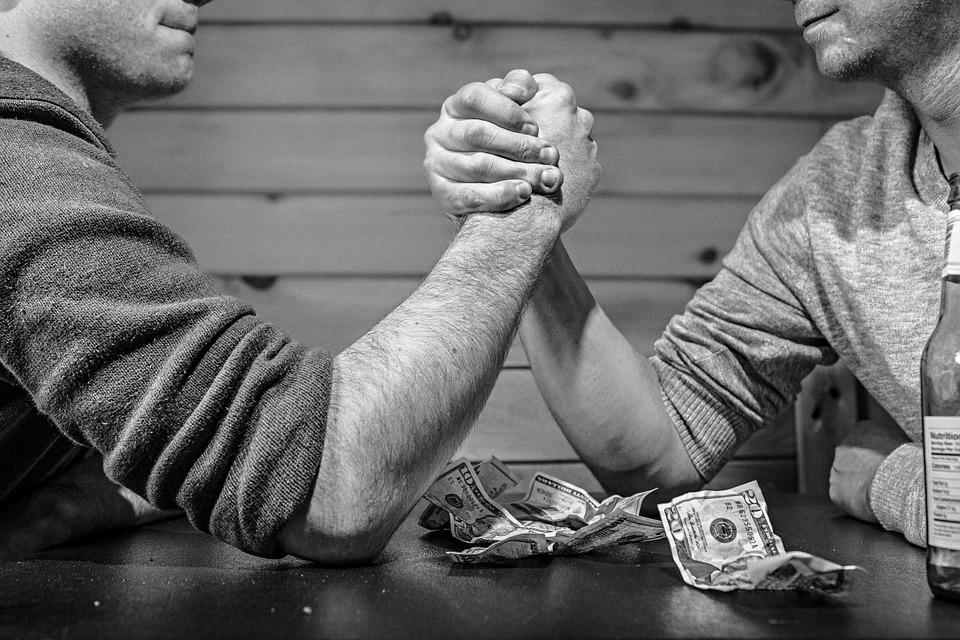 Two men arm wrestling. 