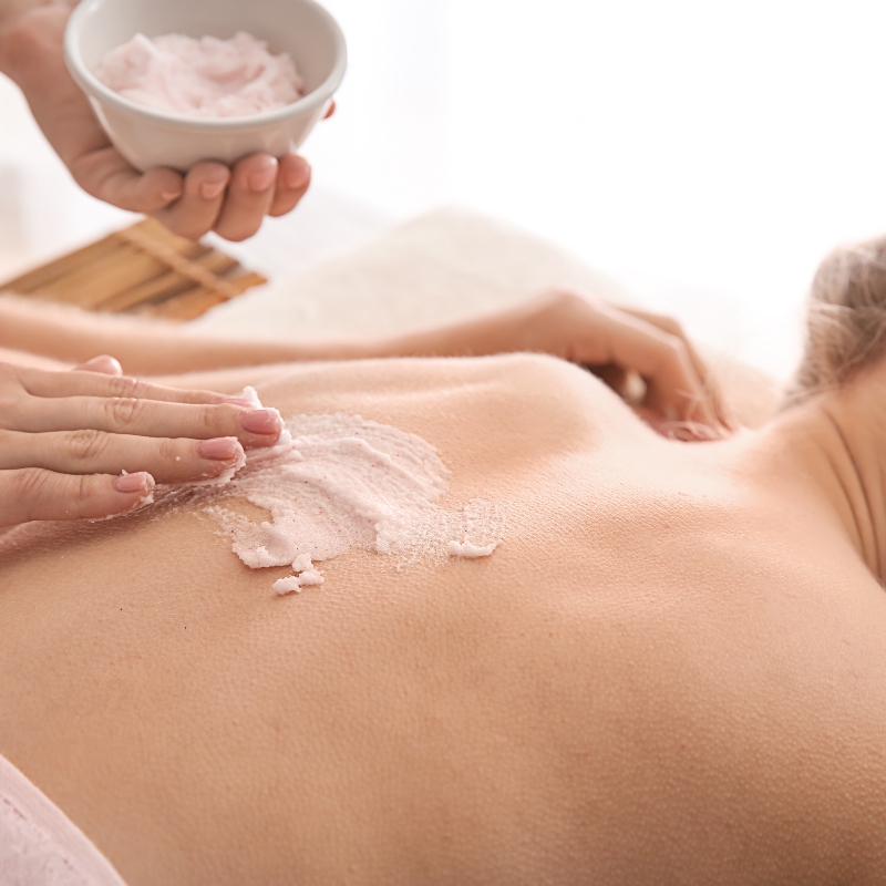 esthetician applying product to client's back