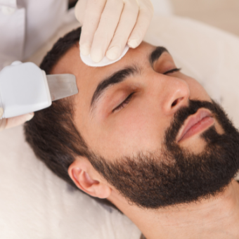 Male client gets ultrasonic exfoliation